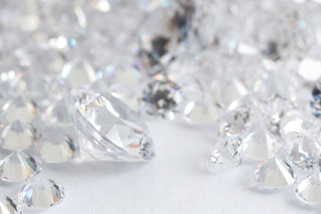 Many shiny diamonds on light background, closeup