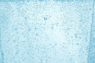 Soda water with bubbles of gas in glass, closeup