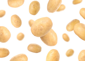Raw potatoes in air against white background