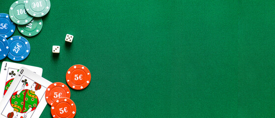 Chips, dices and playing cards for gambling games on table in casino