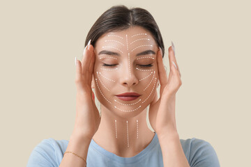 Beautiful young woman doing face building exercise on beige background