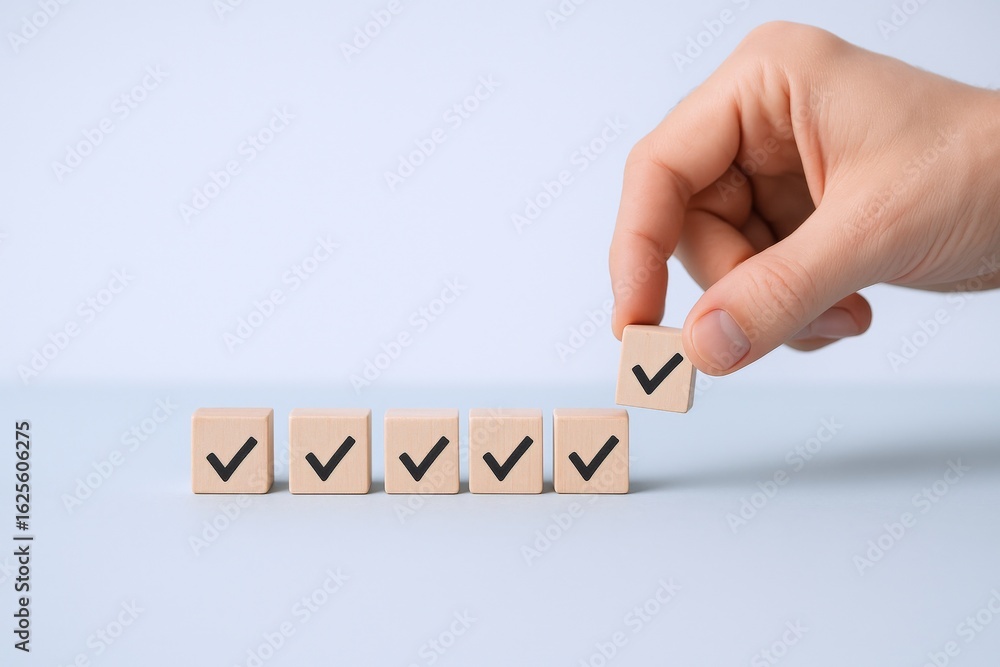 Poster hand arranging wooden blocks with check marks on blue background, representing approval and task com