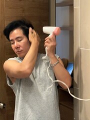 Stylish Young Man Blowing Hair for Cool Look