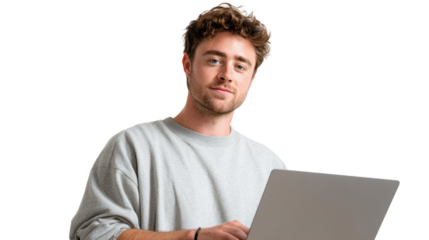 Young man working on a laptop, smiling at the camera, isolated on a white background.