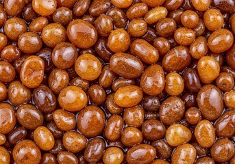 Smooth organic brown stone pebbles with natural gloss, ideal for textured backgrounds and design