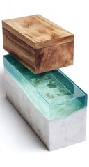 Fototapeta premium Two rectangular boxes, stacked, showcase contrasting materials. A light brown wooden top box sits atop a larger box of white marble, with a teal-colored resin filling the space between.