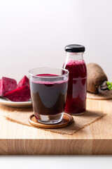Fresh beetroot juice in glass and bottle on wooden, Healthy drink