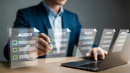 Man in suit reviewing audit checklist on laptop screen with digital interface overlaying documents