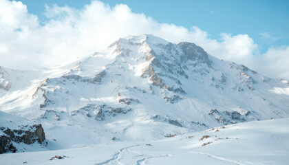 Majestic snow-capped mountain range under clear blue sky