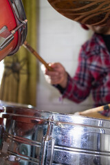 close-up of an acoustic drum kit and a musician