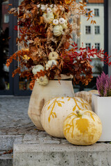 Exterior Beautiful cozy atmospheric halloween pumpkins decorated on porch. Autumn leaves and fall...