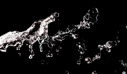 Water splash on black background. Drop pattern. Drop splash motion. Droplet background. Water splashing background. Water fall. Rippling water background. Splash motion.
