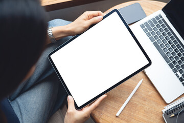 Mockup blank screen digital tablet. Woman holding digital tablet with blank white screen with...
