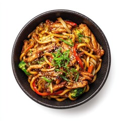 Bowl of stir-fried udon noodles with chicken and vegetables