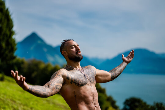 Muscular man beauty. Muscular torso with water drops. Muscular guy in nature landscape. Healthy lifestyle and energy. Bare chest. Fitness in nature. Muscular man workout with splash water.