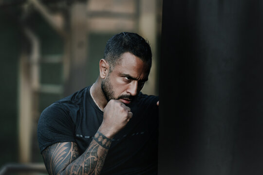 Punch. Portrait of muscular sport man. Fists fight. Mans fight, punches. Kicks up. In the outdoor boxing arena. Man ready for boxings challenge. Man fight. Boxings punch fight. Boxing sport.