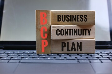 Wooden Blocks Displaying Business Continuity Plan on a Computer Keyboard