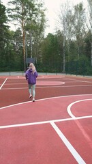 Fototapeta premium Running girl preparing for competition, race or marathon. Motivation, training for health and well-being on city streets, parks or roads. Sports, exercise, training and energy.