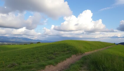 Fototapeta premium Lush green hills under a cloudy sky