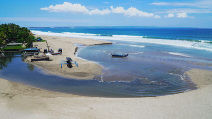 Aerial view of a beautiful sandy beach meeting the turquoise ocean in Bali, Indonesia. A...
