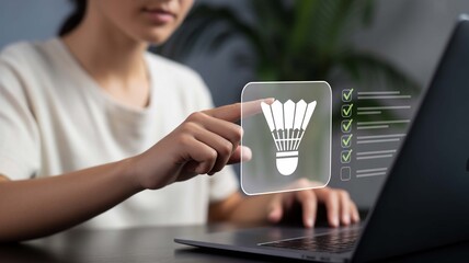 Woman's hand interacting with a digital checklist featuring a shuttlecock icon, symbolizing task completion and online progress tracking in a modern setting