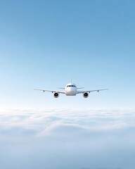 Fototapeta premium An airplane flying above the clouds under a clear blue sky.