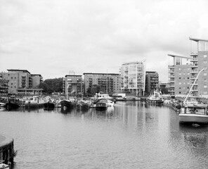 Boats reflecting in the water of a modern marina