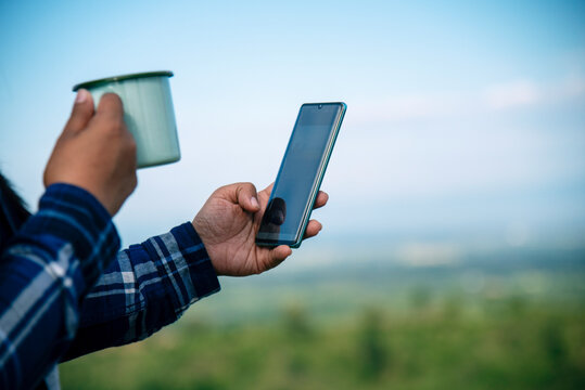 Close up women hands holding coffee cup smartphone E-commerce online Shopping website Reading Article Blog vlog. Young Woman hands holding mobile phone drinking Coffee Cup technology lifestyle