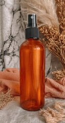 Amber glass spray bottle, centered on a textured background of muted earth tones