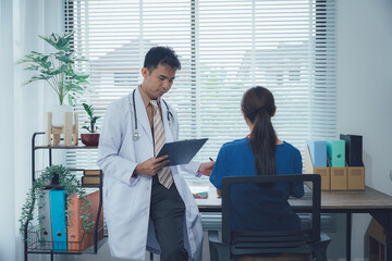 Obraz premium Attractive asian woman nurse and doctor working with smiling and freshness together to takecare ill old senior patient in Planning, writing and healthcare team in office hospital