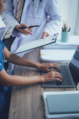 Attractive asian woman nurse and doctor working with smiling and freshness together to takecare ill old senior patient in Planning, writing and healthcare team in office hospital