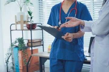 Medical Consultation: A focused snapshot of two healthcare professionals engaged in thoughtful...