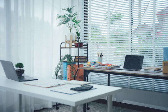 Modern Workspace: A bright and inviting office space with essential furniture and a touch of nature, offering a calm and productive environment.