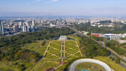 Drone panorama of Curitiba Botanical Garden with lush surroundings and the city skyline under a...