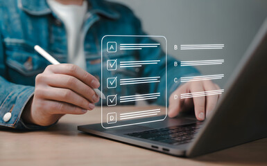 Online survey completion on laptop shows user satisfaction and customer feedback with digital pen for efficient data collection and analysis