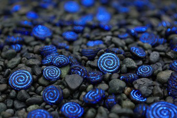 Dark stones, glowing blue spirals