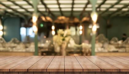 Empty wooden table top with lights bokeh on blur restaurant background.	