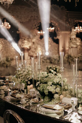 luxury wedding dining table decoration with white roses with wedding altar and lights background 1