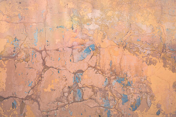  Peeling plaster and paint from the base of the wall as an abstract background.