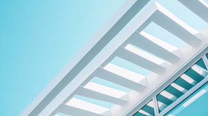 Obraz premium Modern building's geometric design against a light blue sky. White beams create sharp angles, making for a minimalist and contemporary photo.