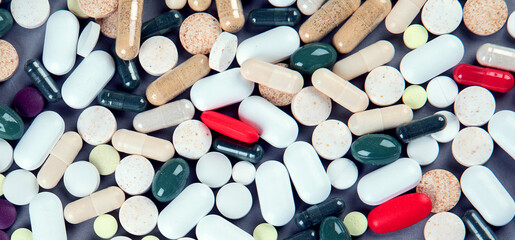 Heap of pills on grey background