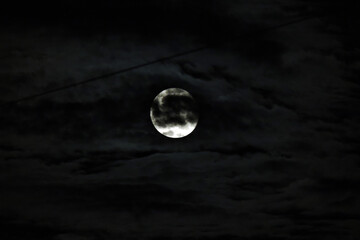 Mysterious full moon in dark clouds