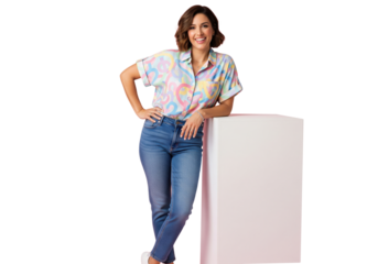 Happy smiling casual young woman standing leaning on a white cube, isolated on a transparent background