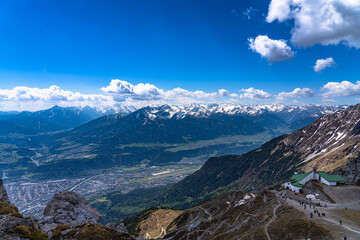 Aerial panorama view of Innsbruck city and south Tyrolean Alps massif from Hafelekarspitze peak in spring on a sunny day, Innsbruck, Austria
