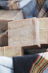 Handmade soap blocks displayed on a textured cloth