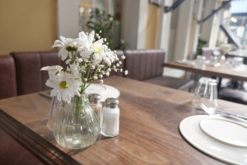 Elegant dining setup with flowers in modern restaurant
