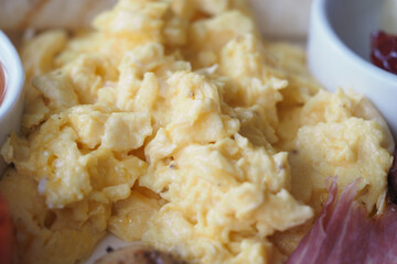 Delicious scrambled eggs served with breakfast sides