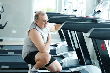 An overweight man is experiencing chest pain and tightness in his chest.
