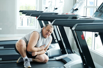 An overweight man is experiencing chest pain and tightness in his chest.