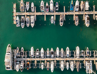 Top view of a luxury yacht and boats along the Miami marina. Aerial shot of a white yacht in...